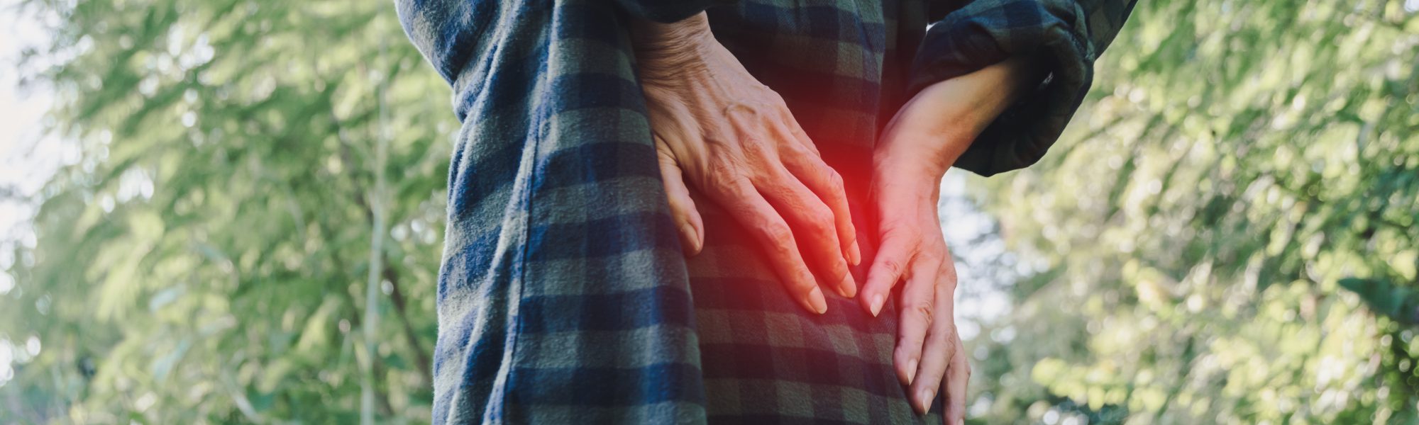 Closeup hands of woman touching her back pain in healthy concept