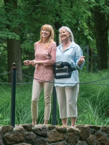 Woman wearing spinalStim device on a bridge